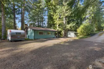 Single story 828 sq ft home off Gravelly Beach Loop NW. Metal roof and 1 car detached garage. Home features a paved driveway for easy access.