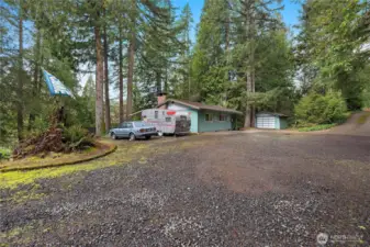 Plenty of parking with RV space, plus a covered deck to relax outdoors.
