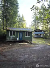 Lot #55 Cabin, and 2-story house on Parcel #56 in the background