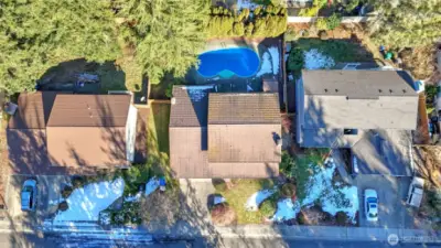 A stunning aerial view showcasing the home and its beautiful backyard pool.