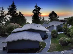 Looking West with the East side of your home in view. Paths lead from the garage (forefront in photo) to the Main house and to the Primary Suite/Separate living space & Shop. To your back (not in photo) is private yard space.