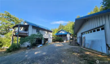 Main Home in middle, ADU & 1st garage on left, second garage on right