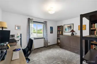 Upstairs bedroom #3 is being used as an office. Murphy bed on wall