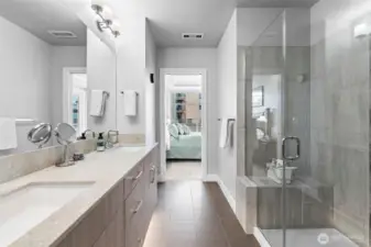 Spa-quality primary bath includes under-lit floating vanity with Quartz counters and dual sinks, custom-tile shower with bench and large walk-in closet with organizers.