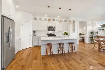 Chef’s dream! Large island, quartz counters, full-height cabinets, and all the details that make cooking a joy.