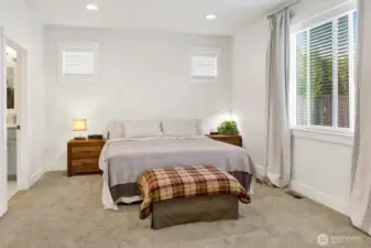 The primary suite is a true retreat, featuring an attached en-suite with a soaking tub, separate shower, enclosed toilet, double sinks, and a spacious walk-in closet.