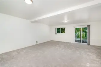 Large downstairs bedroom offers versatility with direct access to the backyard space.