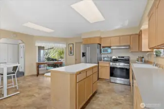 Main floor ~ kitchen w/ SS appliances, brand new gas stove & hood vent.