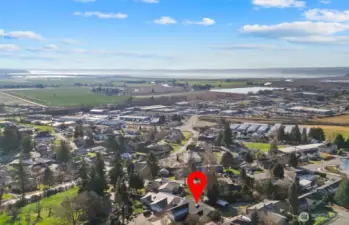 Aerial shot of the home, neighborhood, farm fields, City, Port Susan Bay, Camano Island & Olympic Mountains.