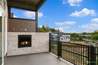 Covered Waterproof Deck w/Custom Iron Railing & Stone Wrapped Gas Fireplace w/Views of River & Park