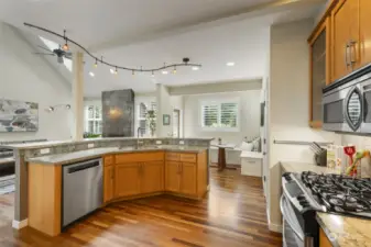 Large center island, stainless appliances, solid granite counters, and cherry cabinets.