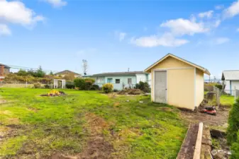 fenced backyard with a shed