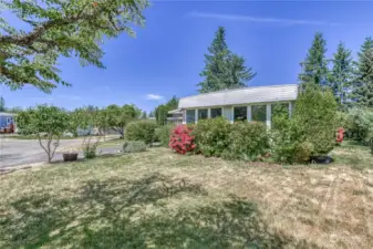 Front level lawn adorned with mature landscape