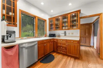 Bright country kitchen with solid wood cabinets glass front uppers—style meets function