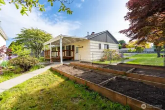 Plant your favorite flowers or veggies in the raised garden beds, perfect for the gardening enthusiast.