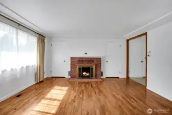 Classic brick fireplace adds charm and warmth to the home.