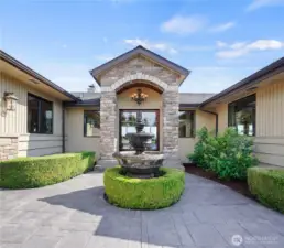 Welcome home to a tranquil entrance featuring a charming fountain that sets the tone for peaceful living