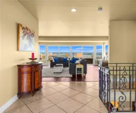 Welcoming entry opens to a stunning living room with a fireplace and expansive windows that capture breathtaking views in every season.