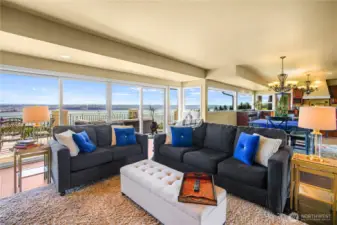 Open-concept living area connects effortlessly to the kitchen and expansive deck, offering the perfect setting for entertaining or simply soaking in the views.
