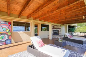 Enjoy outdoor living with a covered patio on the lower level, complete with a gas fireplace for cozy gatherings and relaxing evenings.