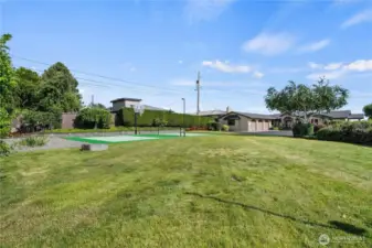 Enjoy outdoor fun on this .72-acre lot featuring a spacious grassy yard and a multi-use sports court perfect for basketball, pickleball, or tennis.