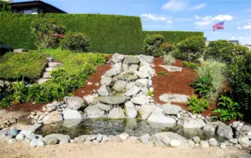 Beautiful waterfall pond wired and ready to convert into a relaxing hot tub—combining tranquility with luxury.