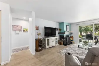 From the spacious great room is the hallway entry to the kitchen to the left and bathroom and bedroom to the right.