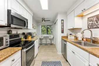 Quaint eating area in the kitchen feels like you're in a park while you enjoy your morning coffee.  The kitchen has a good amount of counter space and storage.  The washer & dryer are tucked away in the closet at the end of the kitchen on the right.
