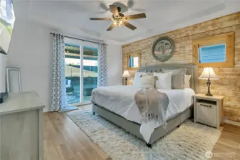 Spacious primary bedroom with slider door to covered patio with hot tub