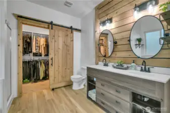Spa like en-suite primary bath with dual vanity and walk in closet