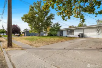Classic mid-century design with attached garage and wide driveway