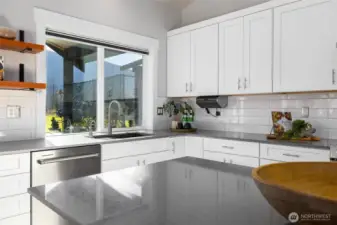 The center island gives plenty of space for dining, storage, baking, entertaining, and meal prep.