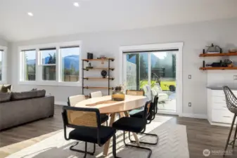 A view out the sliding glass door to the covered patio, fenced yard, and views beyond.