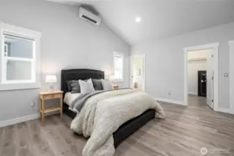 The primary suite with bathroom through the door at the left and the walk-in closet at right.