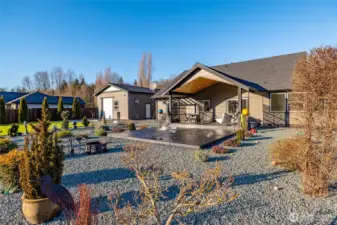 The covered patio and easy-care rock garden in the back yard.