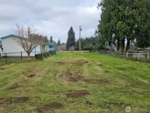 Black chain linked fencing. Parking to the left, with 50amp RV parking and power.