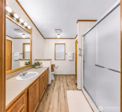 Primary bathroom with a walk-in shower and newer flooring