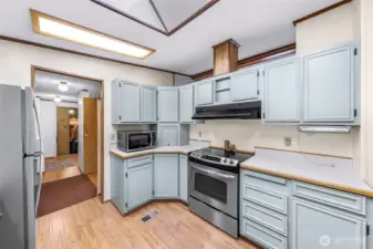 Kitchen and hallway to the left takes you to the laundry room, a pantry and the garage.