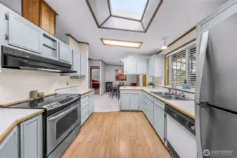 From the kitchen to the dining room.  Lots of light from the skylight