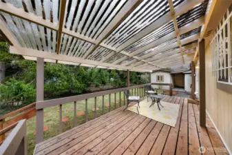 From the covered back deck, potting or tool shed seen to the center/right.