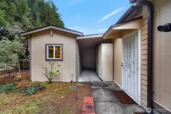 Potting or tool shed with power on the left, storage on the right.  New steel security door to garage on the right.