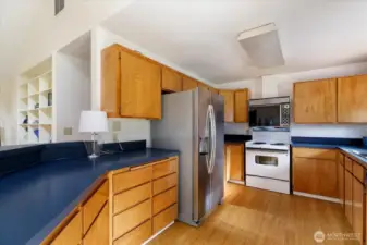 The kitchen's footprint allows for ease of cooking and prepping with ample storage.