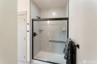 floor to ceiling tiled shower in primary bathroom