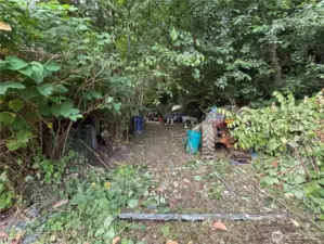 Tractor, pull behind utility trailer, and approximately 6 cars are on the property and shall convey with the sale