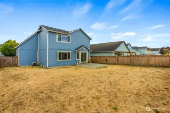 An expansive, fully-fenced backyard awaits your vision!