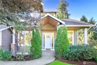 Lush landscaping and an inviting entryway set a welcoming tone.
