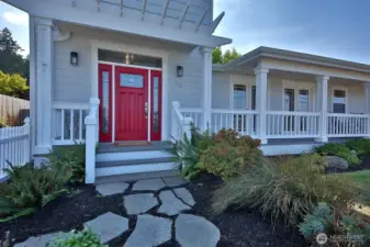 Front entry welcomes your guests, with lovely covered porch wrapping the front of the home offering expansive views of Penn Cove.