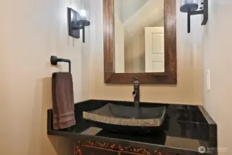 Powder room just off kitchen hallway for convenience.
