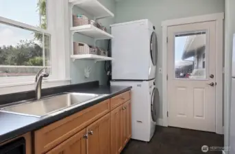 Second kitchen at the back of the home with laundry, sink, refrigerator and a second oven!