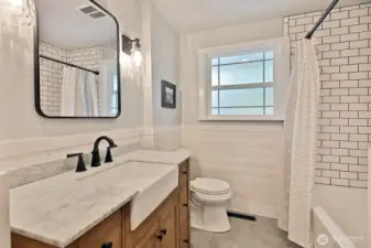 Shared bath has been completely remodeled with light and great storage in mind.
